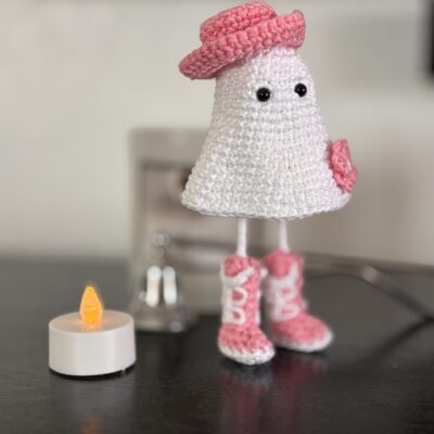 crochet cowgirl ghost with pink boots, hat and flower