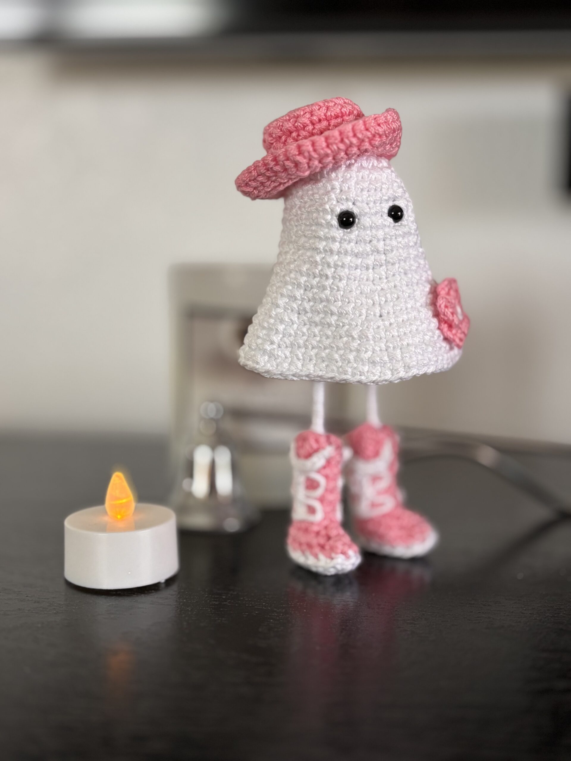 crochet cowgirl ghost with pink boots, hat and flower