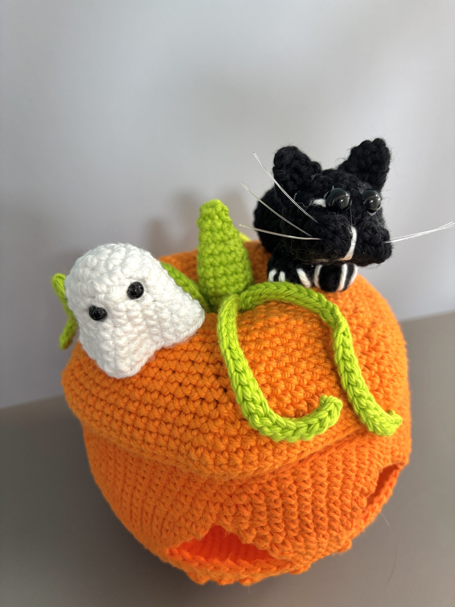 crochet ghost and black cat on pumpkin